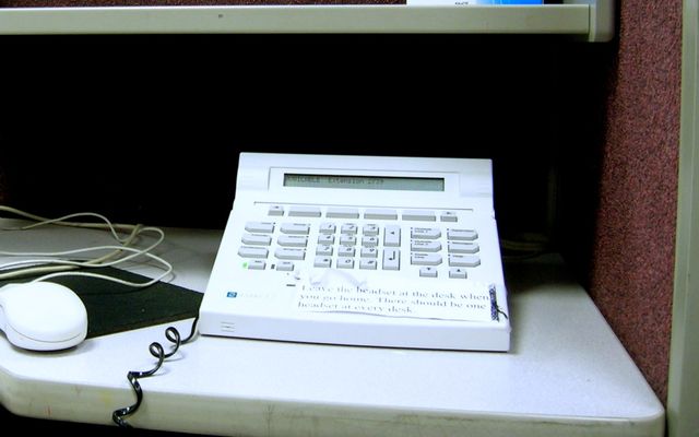 A telephone call center with headsets at work