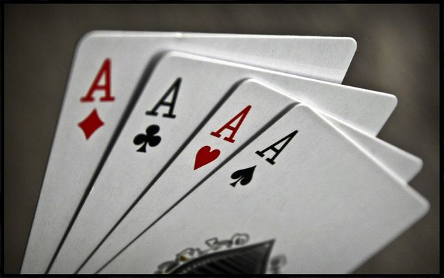 A hand of playing cards and poker chips on a table