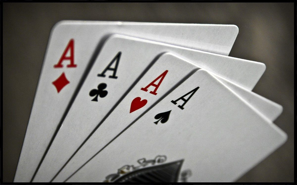 A hand of playing cards and poker chips on a table
