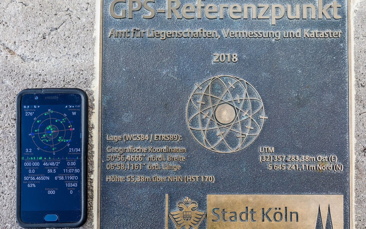 A hand holding a smartphone that shows a map location