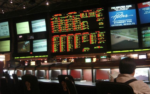 The sportsbook counter and odds screens at a Las Vegas casino