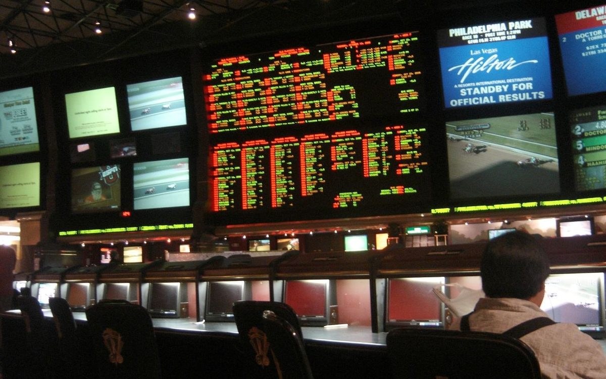 The sportsbook counter and odds screens at a Las Vegas casino