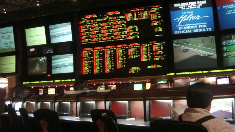 The sportsbook counter and odds screens at a Las Vegas casino